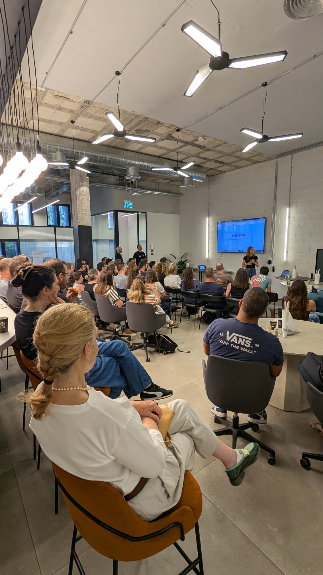 A full room of about fifty attendees seated at Sola Security as Stav Grinboim opens the Meet Elsa talk